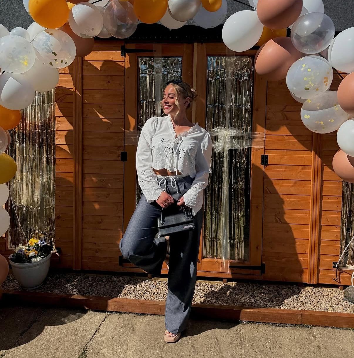Image of Emily stood outside her beautiful salon